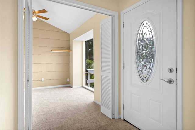 entryway with light carpet, vaulted ceiling, and ceiling fan