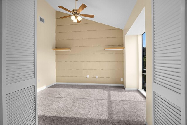 interior space with vaulted ceiling, ceiling fan, and carpet floors