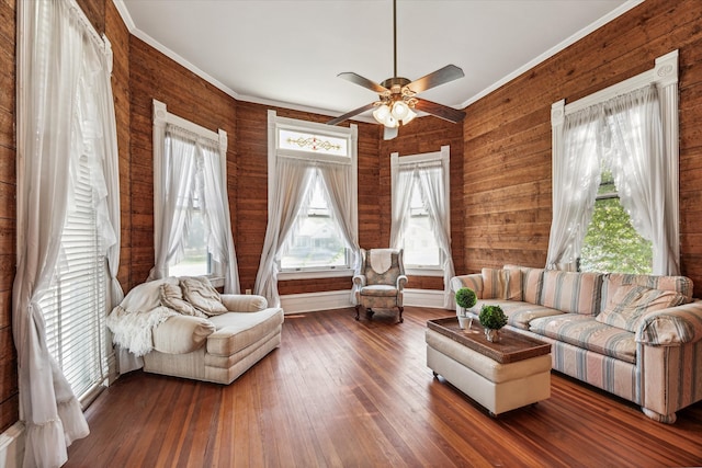 living room with wooden walls, ceiling fan, and dark wood-type flooring