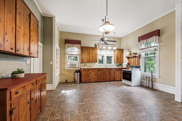 kitchen featuring ceiling fan, tasteful backsplash, sink, white electric stove, and pendant lighting