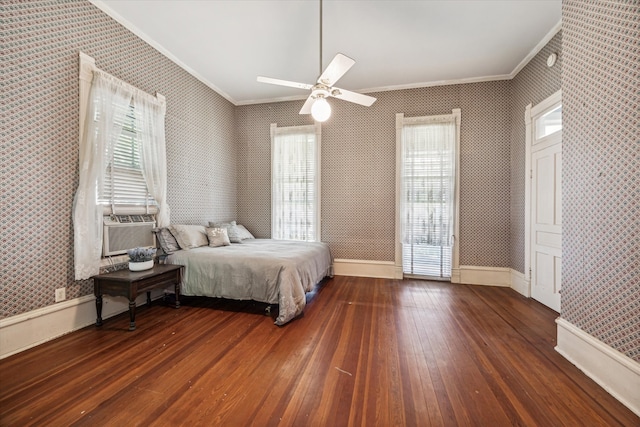 bedroom featuring dark wood-type flooring, ornamental molding, and ceiling fan