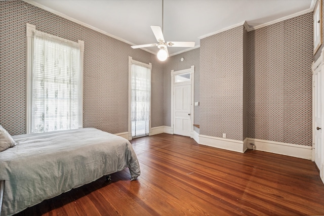 bedroom with multiple windows, dark hardwood / wood-style floors, and ceiling fan