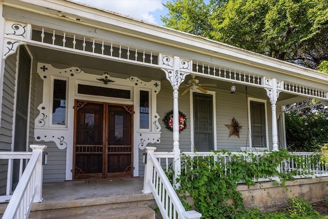 entrance to property with covered porch and ceiling fan