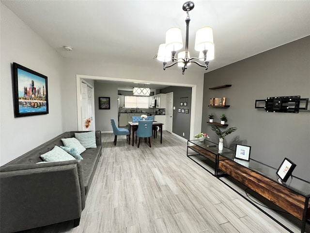 living room featuring a chandelier and light hardwood / wood-style flooring