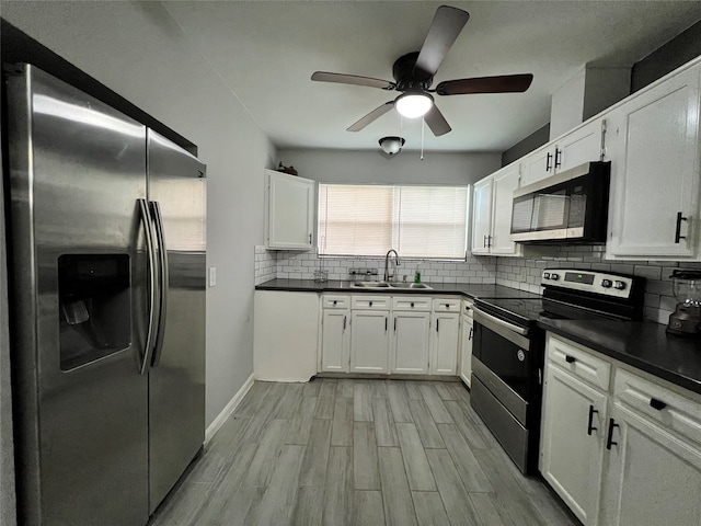 kitchen with stainless steel appliances, light hardwood / wood-style flooring, white cabinets, and sink