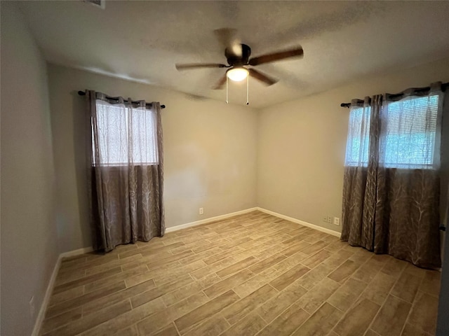 spare room with ceiling fan and light hardwood / wood-style floors