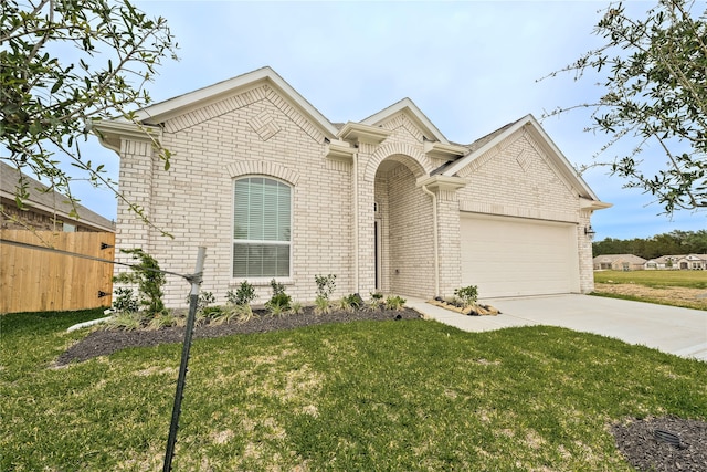 view of front of home with a front yard and a garage