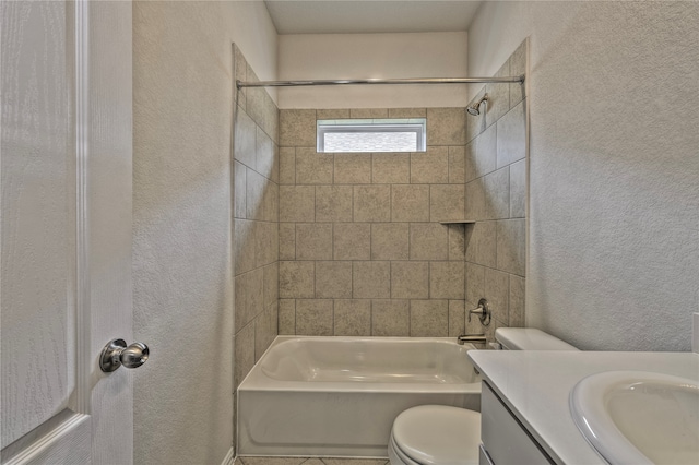 full bathroom featuring toilet, vanity, and tiled shower / bath