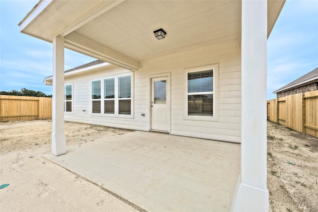 view of exterior entry featuring a patio