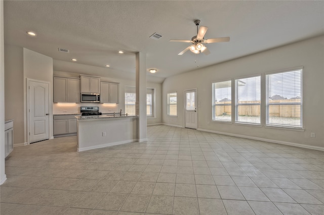 kitchen with ceiling fan, light tile patterned flooring, and appliances with stainless steel finishes