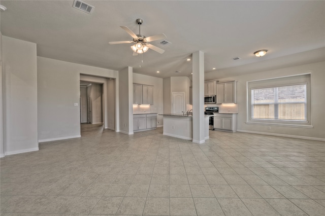 unfurnished living room with ceiling fan and light tile patterned flooring