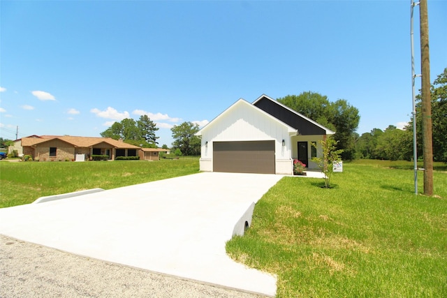 view of front of property with a garage and a front lawn