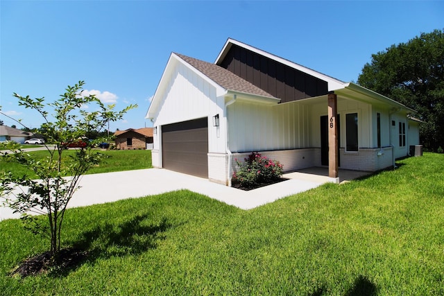 view of side of home with a lawn and a garage