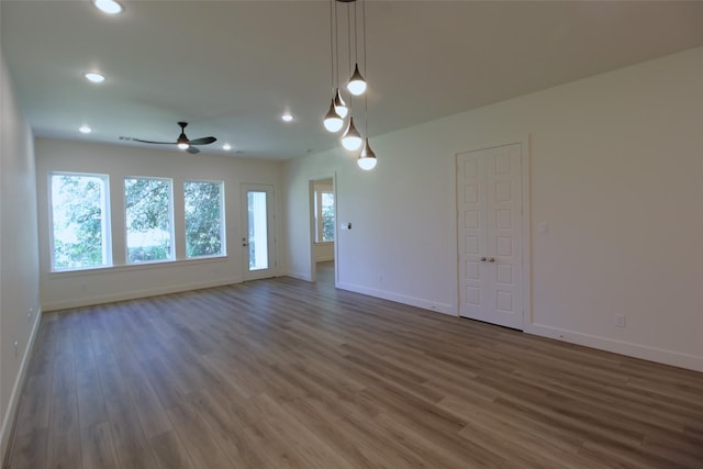 unfurnished room featuring ceiling fan and dark hardwood / wood-style floors