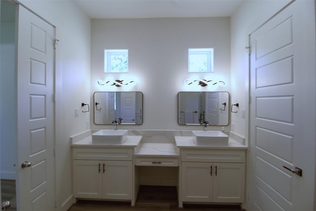 bathroom with a wealth of natural light, hardwood / wood-style floors, and vanity