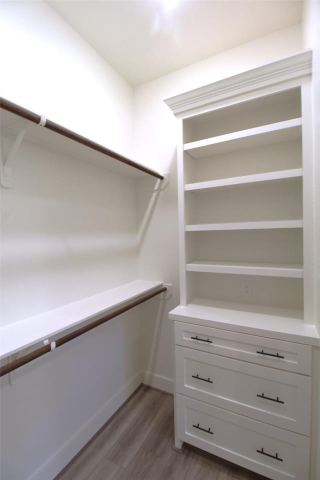 spacious closet featuring hardwood / wood-style flooring