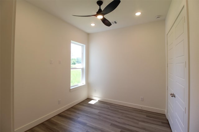 unfurnished room featuring ceiling fan and dark hardwood / wood-style flooring