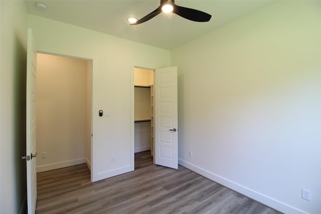 unfurnished bedroom featuring ceiling fan, light wood-type flooring, and a closet