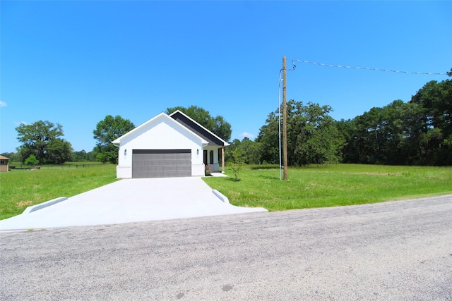 view of front of property with a garage and a front yard