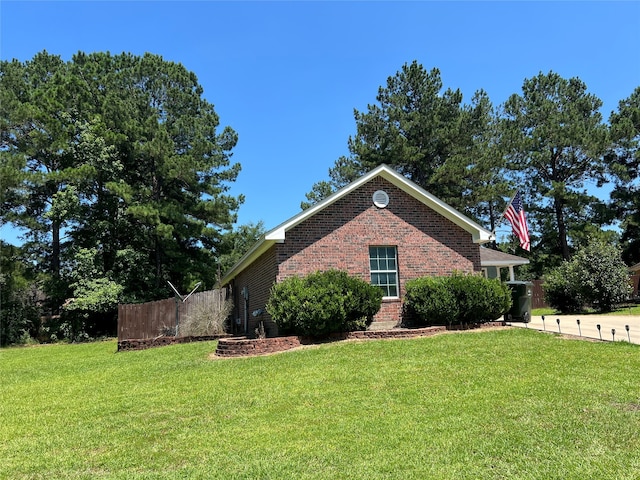 view of side of property with a lawn