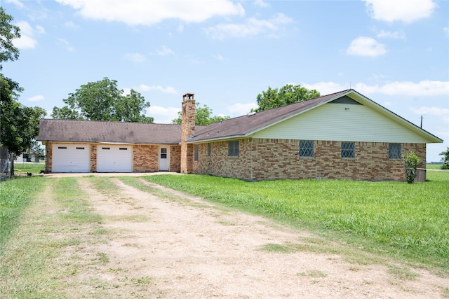 single story home with a garage and a front lawn