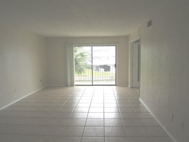 empty room featuring light tile patterned floors