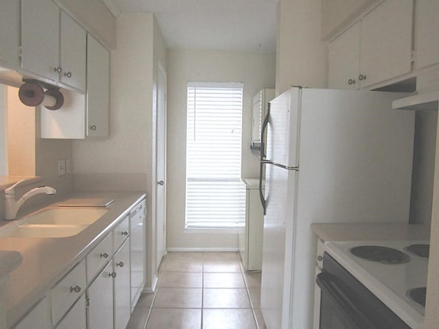 kitchen featuring sink, white appliances, white cabinetry, and light tile patterned floors