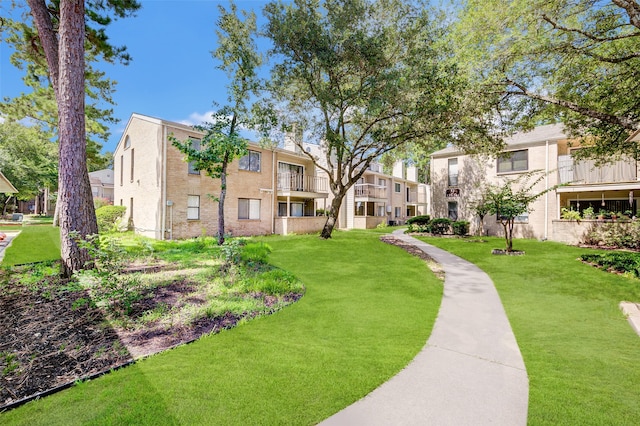 view of home's community featuring a lawn