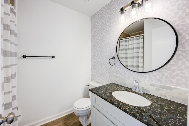 bathroom with vanity, toilet, and hardwood / wood-style floors