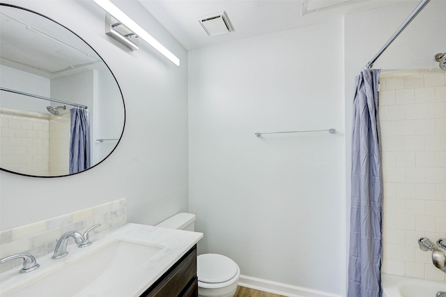 full bathroom featuring vanity, shower / tub combo with curtain, and toilet