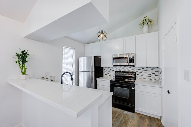 kitchen with lofted ceiling, tasteful backsplash, light wood-type flooring, kitchen peninsula, and appliances with stainless steel finishes