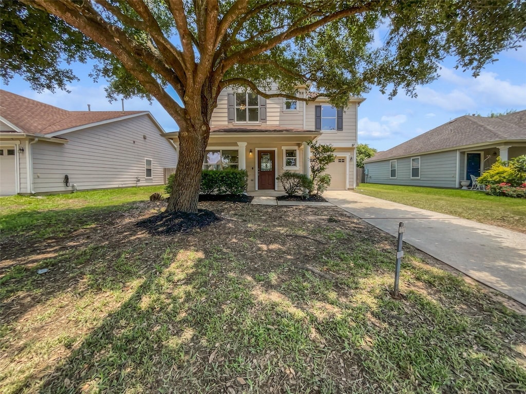 view of front of house featuring a garage and a front lawn