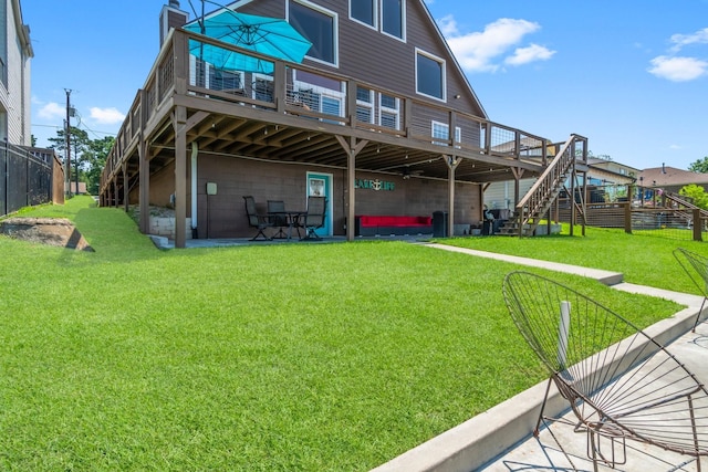 back of house with a lawn and a deck