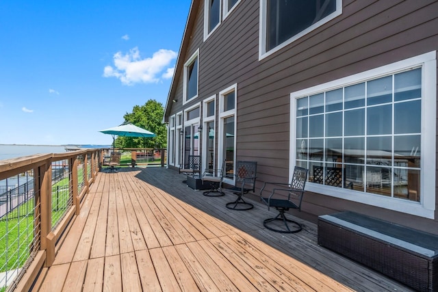 wooden terrace featuring a water view