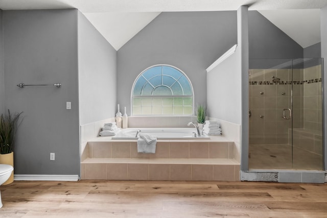 bathroom featuring hardwood / wood-style flooring, lofted ceiling, and independent shower and bath