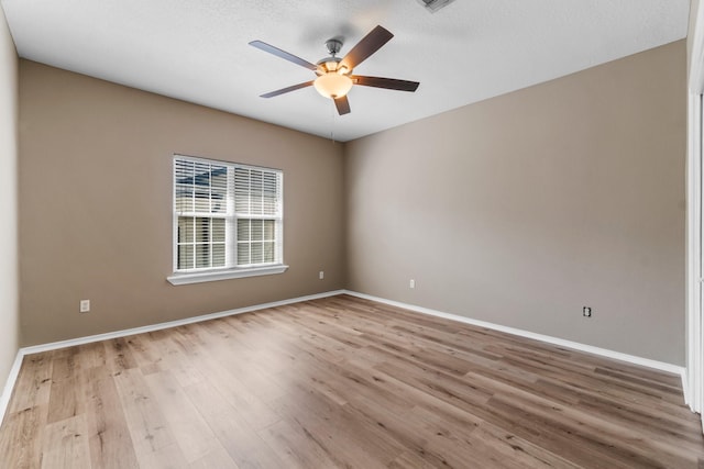 unfurnished room featuring light hardwood / wood-style flooring and ceiling fan