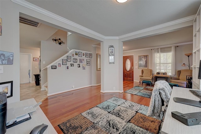 living room with light hardwood / wood-style floors and crown molding