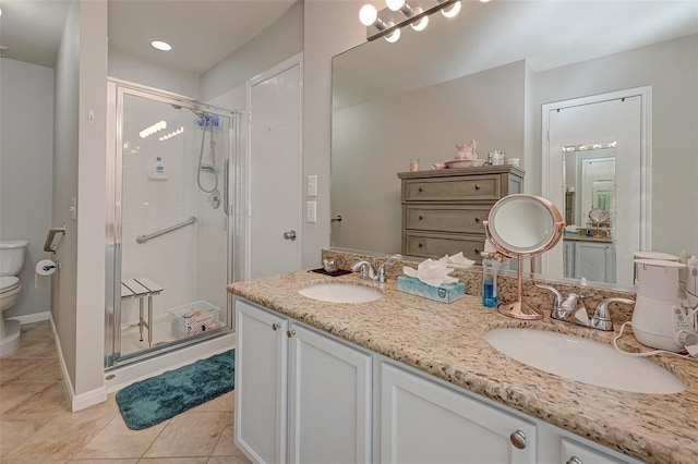 bathroom with tile patterned floors, vanity, toilet, and walk in shower
