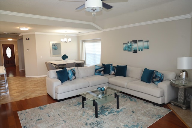 living room with ceiling fan with notable chandelier, hardwood / wood-style flooring, and ornamental molding