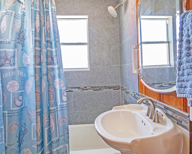 full bathroom featuring a sink and shower / bathtub combination with curtain