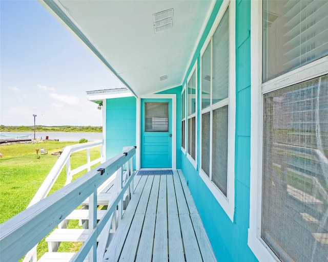 balcony with a water view and visible vents