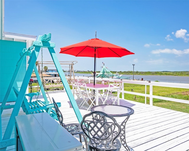 deck featuring a lawn and a water view