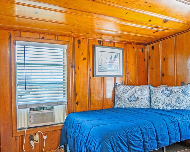 1214 County Road 201, Sargent, TX 77414 - bedroom with wood ceiling, multiple windows, and wood walls
