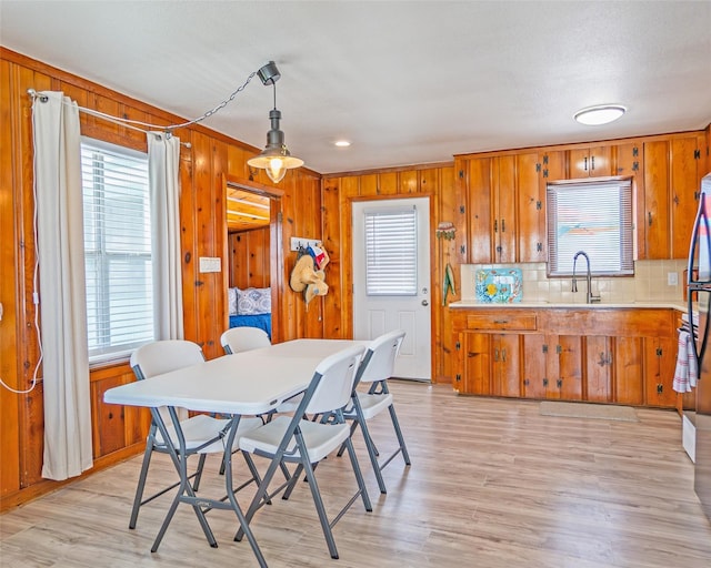 1214 County Road 201, Sargent, TX 77414 - dining area featuring wooden walls and light wood finished floors
