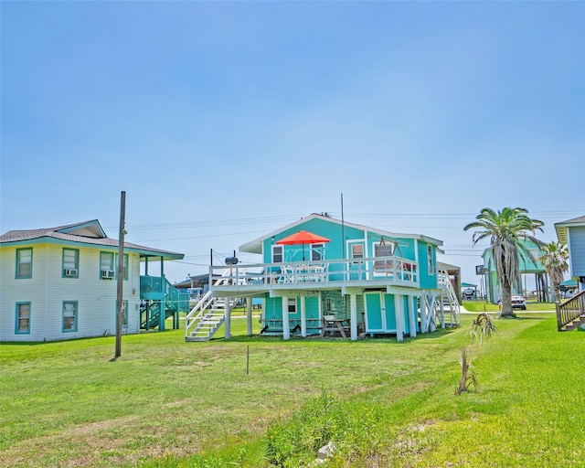 exterior space with stairway, a deck, and a lawn