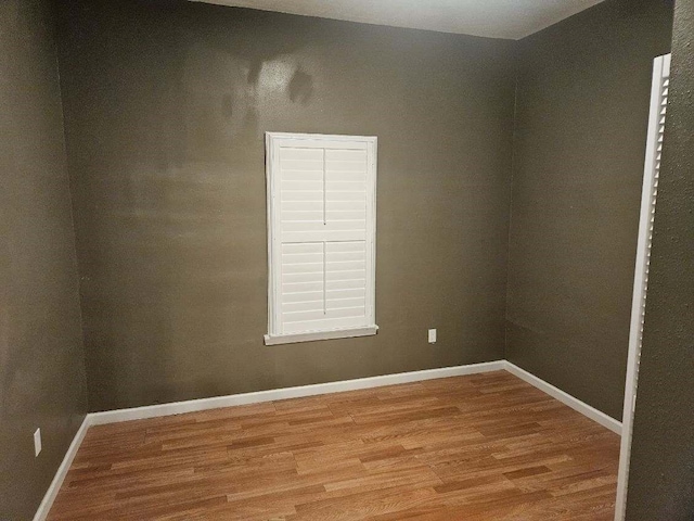 unfurnished room with wood-type flooring