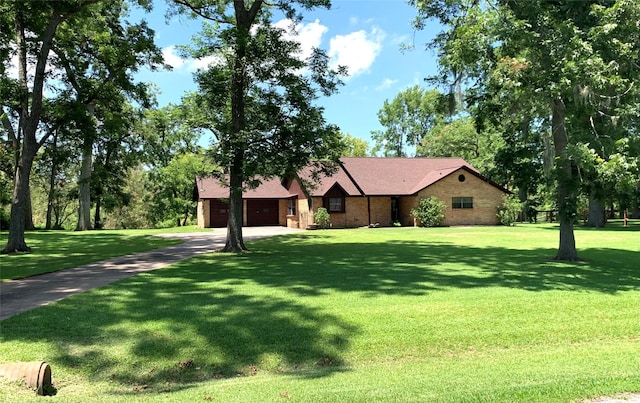 view of front of house with a front yard and a garage