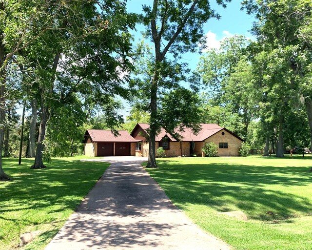 view of front of property featuring a front yard, a garage, and an outdoor structure