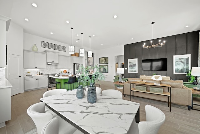 dining room featuring light hardwood / wood-style flooring and an inviting chandelier