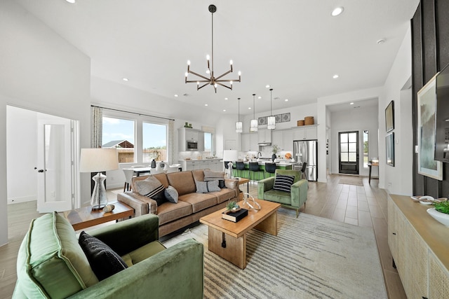 living room with light hardwood / wood-style floors and an inviting chandelier